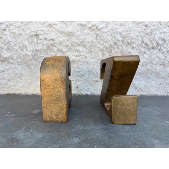 The letter “a” & “z” bookends made of a heavy cast metal design by The Curtis Jere Company. Both bookends are signed and...