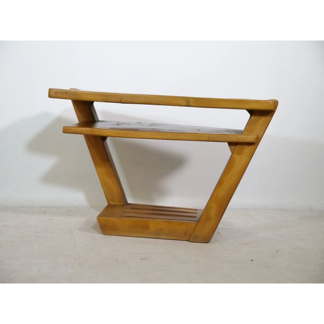 1960s coffee table made of solid elm/elm wood in a mid-century design. Its distinctive slanted frame features an...