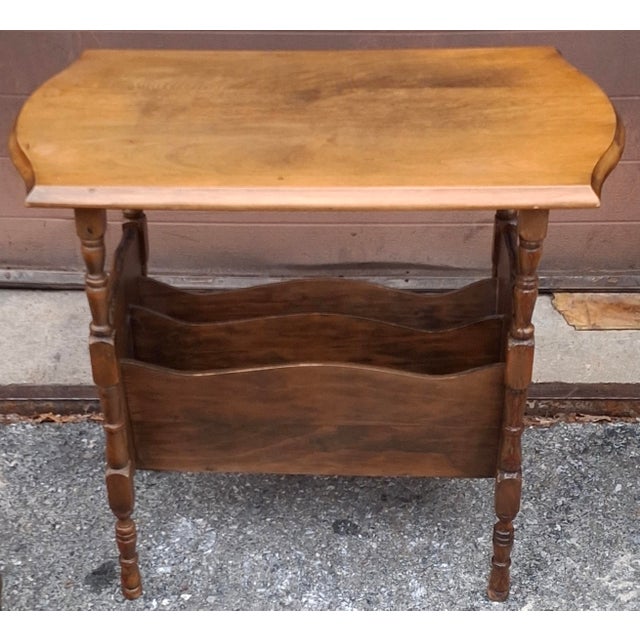 An Early American Style Walnut Magazine Rack Side Table with two large magazine slots measuring 17" wide and 3" in depth....