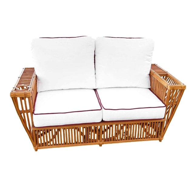 This beautifully restored striking Nantucket settee features classic stick rattan framing with tightly woven wicker...
