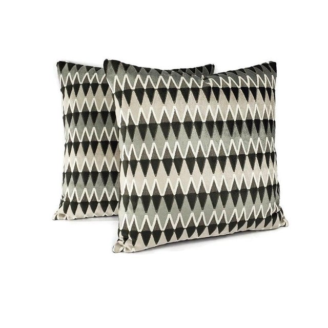 This pillow has black, gray, and white cut velvet in a geometric diamond pattern. The pillow is backed with a solid...