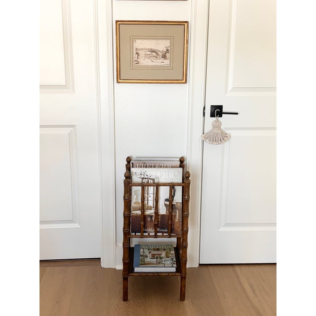 Charming faux bamboo magazine rack featuring finely turned hardwood elements designed to imitate natural bamboo. Ideal...