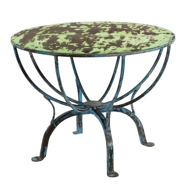 Imagine a piece of furniture that tells a story of time, travel, and artistic soul. Our Vintage Distressed Metal Round End...