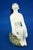 a delightful, hand-sculpted, vitrified majolica ceramic sculpture depicting a seated nude woman with her legs folded and...