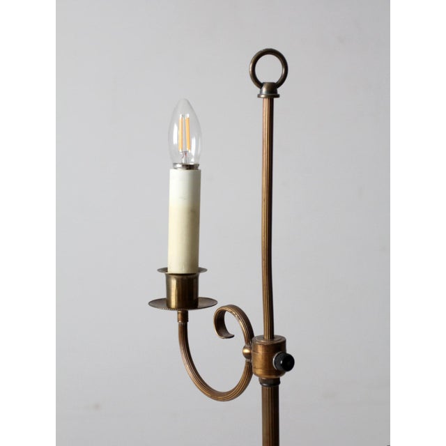 This mid-century floor lamp embodies the elegance of the Regency era with its graceful bridge arm and antique brass...