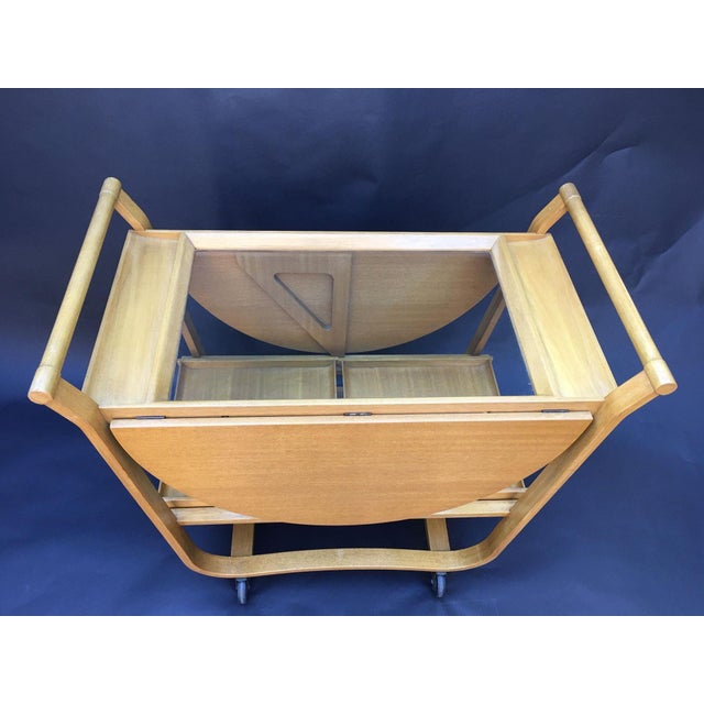 A sophisticated Edward Wormley for Dunbar drop-leaf bar and serving cart, dating to the early 1950s. The design is...