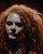 This artwork presents a striking portrait of a figure with voluminous, fiery red hair, capturing an intense emotional...