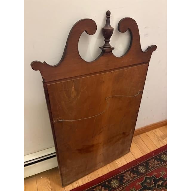 Antique Georgian Chippendale-style mirror that would look stylish hanging on the wall or over a mantel. Mirror features...