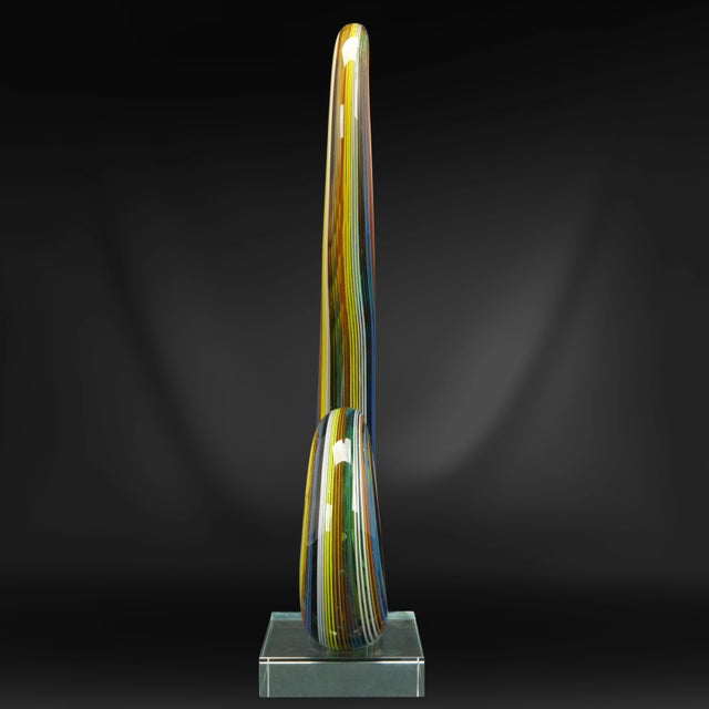 A tour de force of color and modernism. The hand-blown curving rod with many strands of color running through the clear...