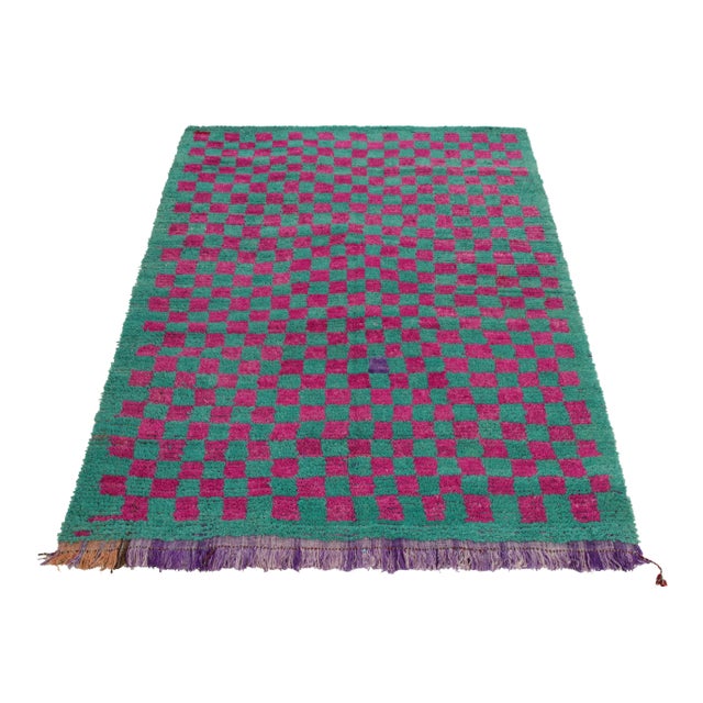 Coming from Turkey circa 1950-1960, this vintage 5x7 Tulu rug enjoys a magenta checkered pattern sitting boldly on...