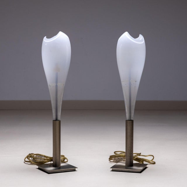 Pair of petite table lamps featuring white Murano glass shades in a teardrop design, complemented by nickel-plated bases....