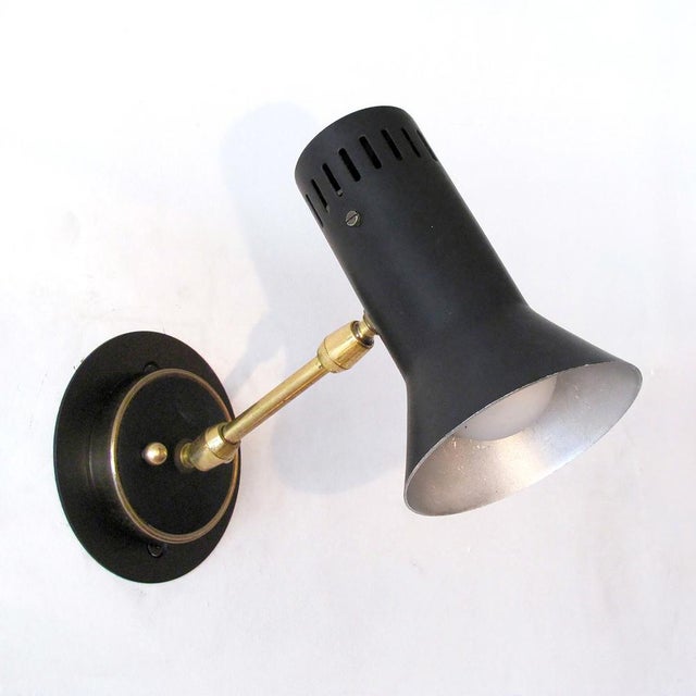 Wonderful, articulate pair of 1950s Italian wall lights, double joint brass arms, slotted partially conical shades, wired...