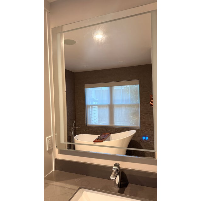 A sleek, frameless LED bathroom mirror that elevates any modern or spa-inspired space. Backlit edge lighting creates a...