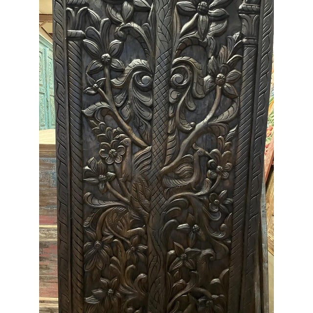 Bring an enchanting sense of nature and old-world artistry to your interiors with this vintage hand-carved wood barn door....