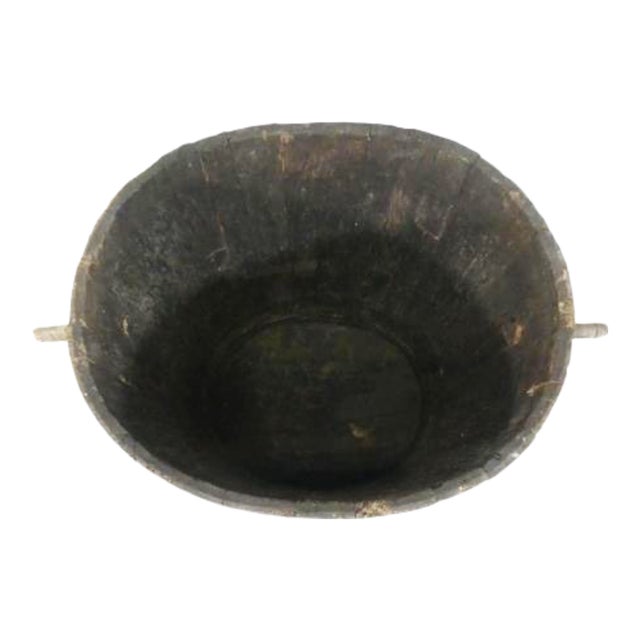 This would have been used in vineyards for collecting grapes during harvest. There are handles on each side which have...