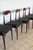 Superb set of 5 chairs in the style of Scandinavian designer Niels Otto Møller (model no. 71). Teak frame and black vinyl...