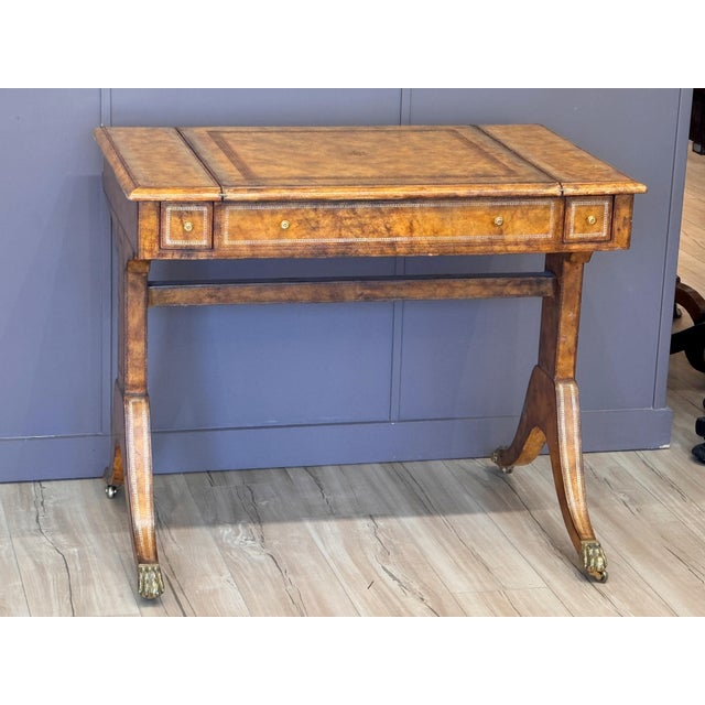 A mid-20th C. tooled leather-clad games table with a rectangular top opening to reveal reversible game surfaces, including...
