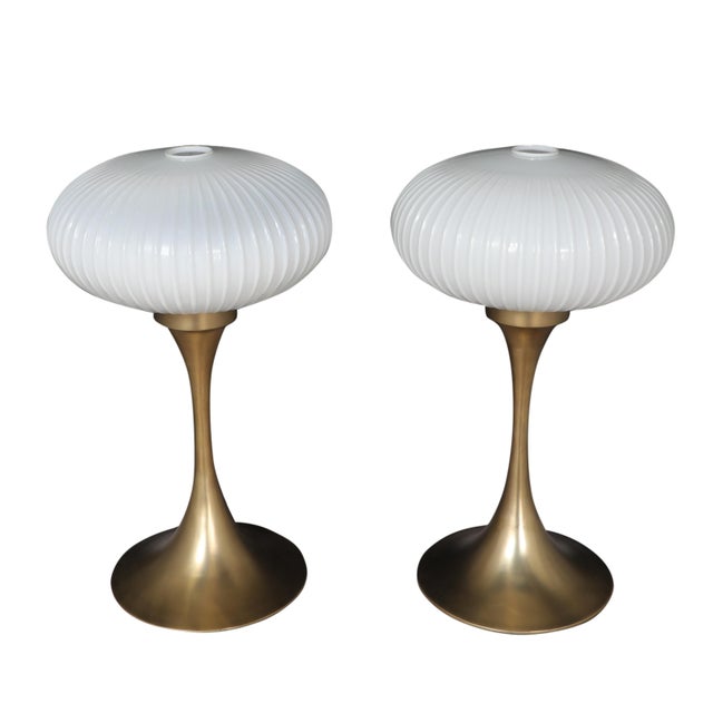A pair of stunning tulip shaped brass table lamps with art glass opalescent shades with a ribbed, textured pattern....