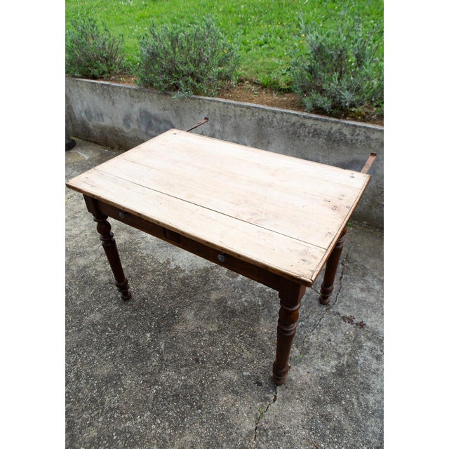 French farmhouse or kitchen table, dating from around 1900. A rustic piece with clean lines, ideal for its original use as...