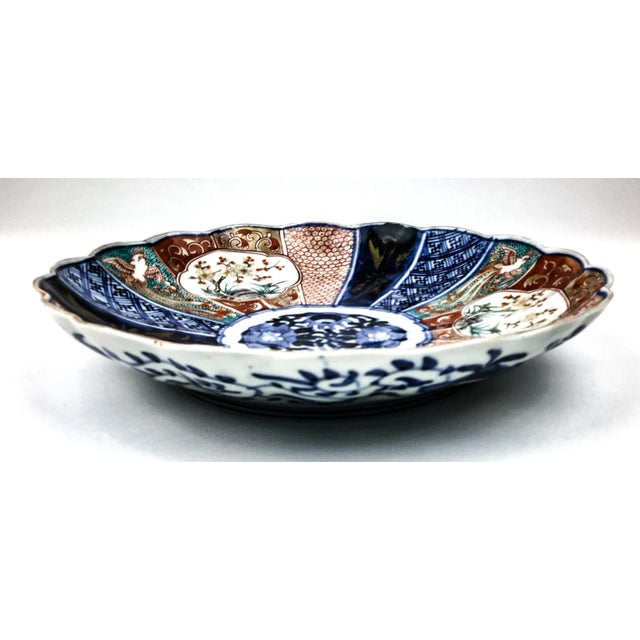 Gorgeous fan design with all the traditional colors of Japan. The rim is a cool scallop curvy shape. The under-gaze blue...