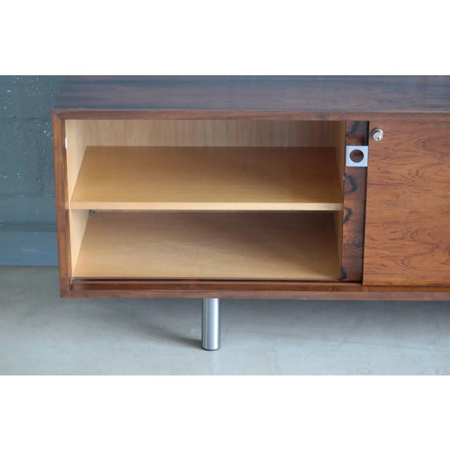 A sleek elegant and very modern Danish 1960s Brazilian rosewood credenza attributed to the queen of Danish Modern, Bodil...