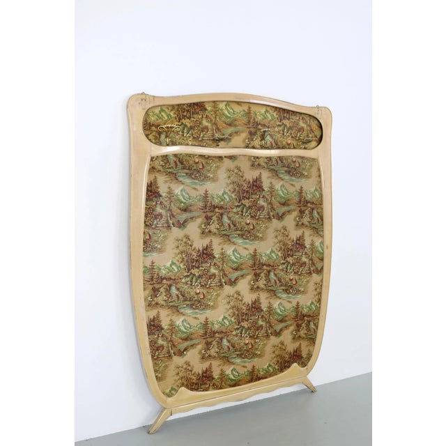 This is an original Italian 50s wall-mounted coat rack in lacquered wood with an upholstered cover. It has a cover with a...