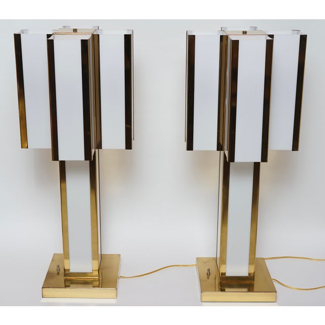 This is a pair of Mid-Century Modern Italian brass and ivory table lamps designed by Romeo Rega in the 1970s These are...