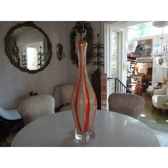 Striking high quality Murano glass lamp 28.25" H with alternating orange and white vertical stripes mounted on an acrylic...
