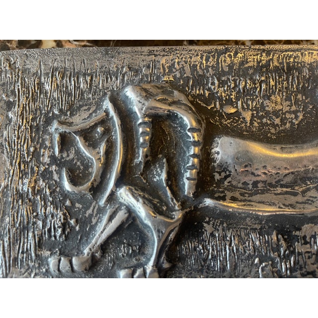 Pewter box with a raised Lion top. The cover is longer than the box.