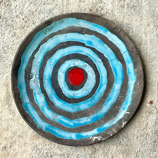This stunning vintage studio pottery charger from the late 20th century is a true statement piece, hand-painted with...