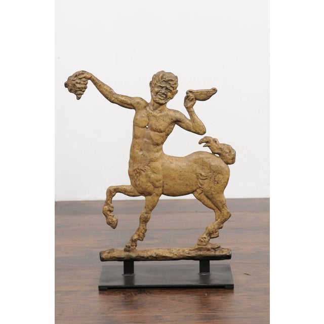 A French painted iron centaur sculpture from the early 20th century, mounted on a custom base. This French decorative...