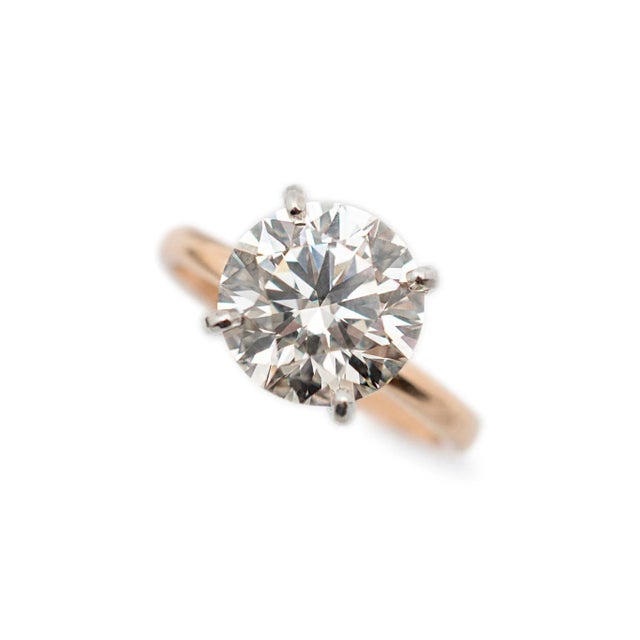 One ladies 18K white & rose gold, diamond solitaire ring with a half round shank. Engraved with "18K". In excellent...