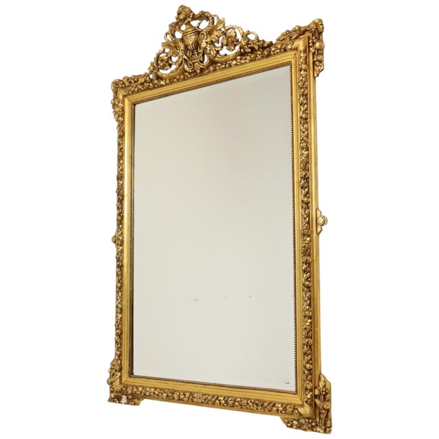Antique Napoleon III floor mirror featuring beveled glass, crafted from pine and gilded gesso; it boasts an impressive...