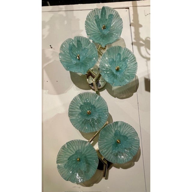 The product is a pair of Murano green flower disc sconces, Made with intricate floral patterns in a beautiful green hue,...