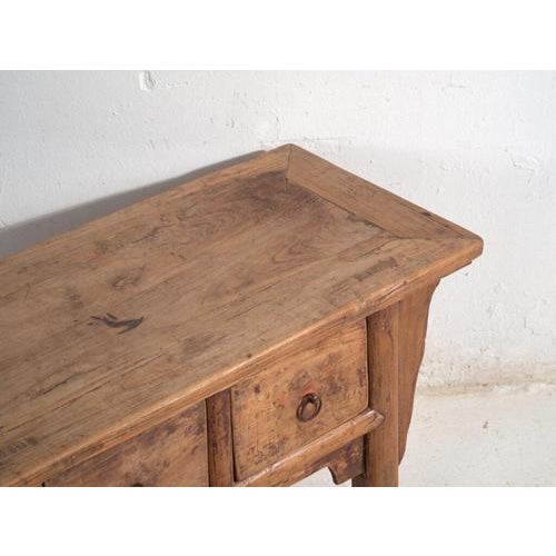 Low console table in elm wood, originating from Shanxi province in northern China and dating to circa 1930. A piece of...