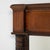 Here is a mirror, its dark walnut carved frame with pediment crest the first thing to catch the eye. The piece dates to...