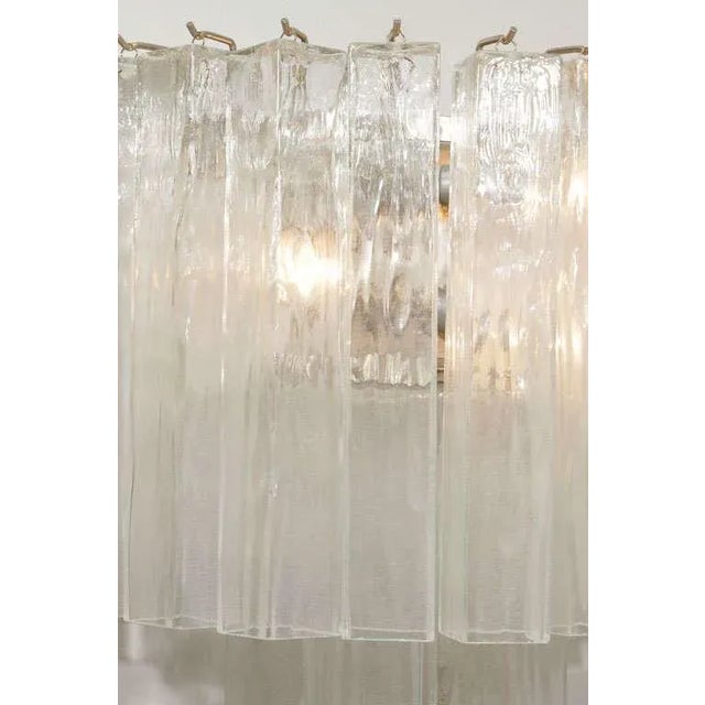 A dazzling pair of Murano glass "waterfall" sconces with square glass tubes hanging in two tiers.