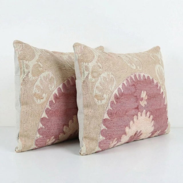 This beautiful 16'' x 24'' hand-embroidered Suzani pillow cover set was made from authentic Uzbek cotton fabric. The...