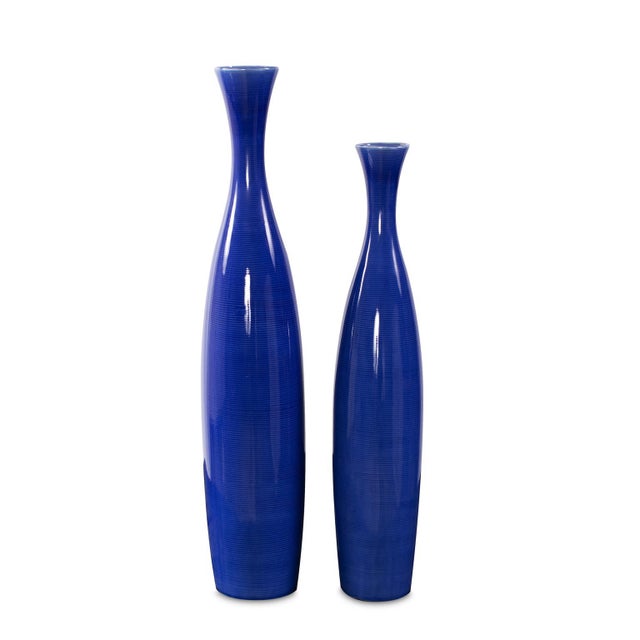 This tall vase set is fashioned from ceramic and finished in a vivid cobalt blue glaze. The set includes a large and small...
