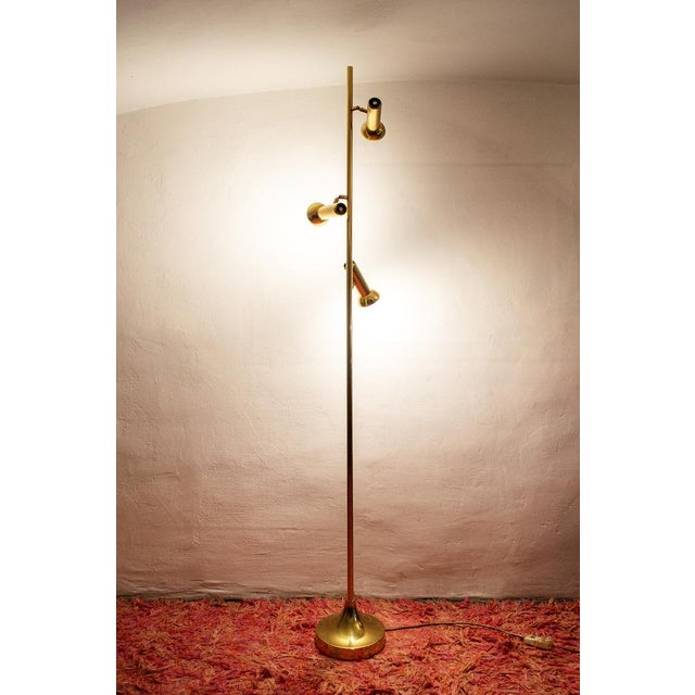 Three-light floor lamp in brass. Producer Reggiani 70s I have official proof of authenticity such as vintage catalogs,...