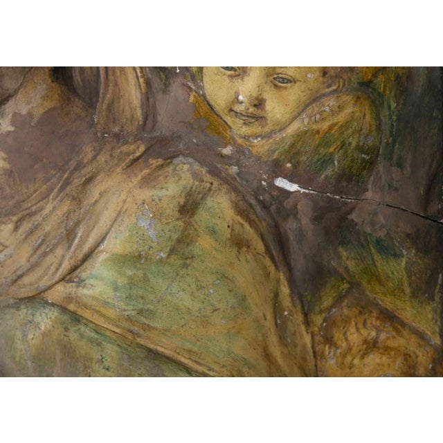 Madonna and Child is a beautiful colored chalk low relief realized in the 19th Century by Anonymous Artist. Frame...