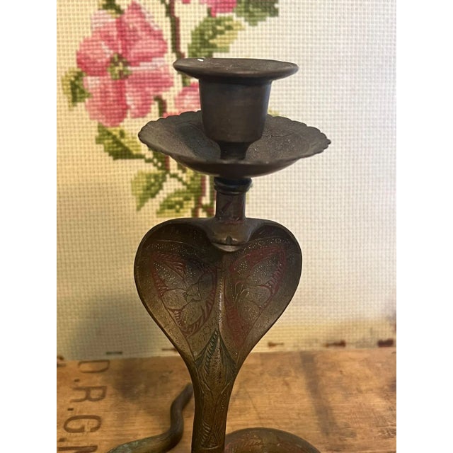 Possibly Brass in material, not Confirmed. Depicting a Snake adorned with ornate floral detail and patina. Vintage...