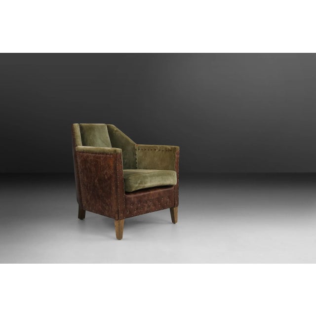 Art Deco armchairs made around 1930. Made of green velvet and brown Leatherette. Has some nice brass details.