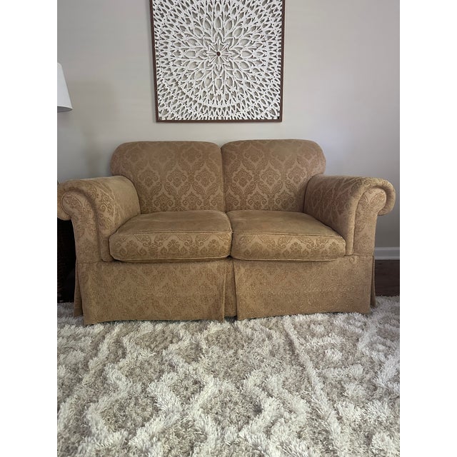 Beautiful traditional loveseat by Sherrill Furniture, upholstered in a soft neutral beige and taupe damask fabric. This...