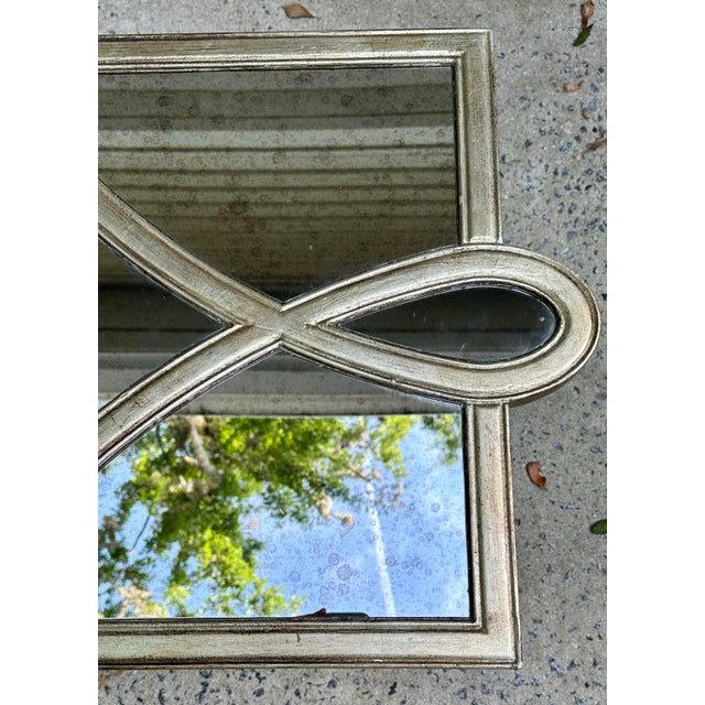 Mirrored coffee table in a silvery gold champagne finish. Cut out design on top is interesting and makes the table stand...