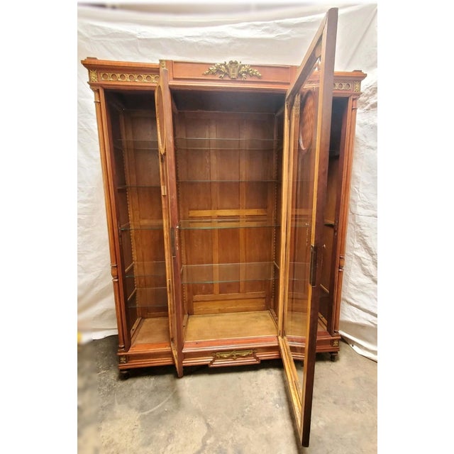 Elevate your interior with this exceptional late 19th-century French breakfront vitrine, a refined statement piece dating...