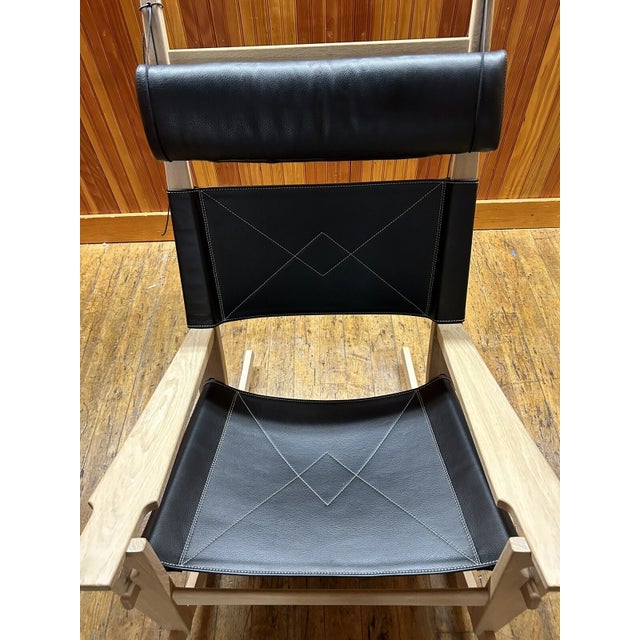 Attributed to Hans Wegner GE 673 Keyhole Rocking Chair is a stylish and comfortable addition to any indoor living space....