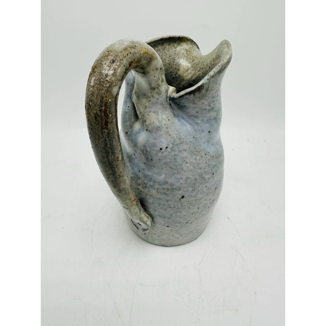 Decorative and organic, this pottery piece is a soft neutral grey with a flat finish, very primitive yet modern