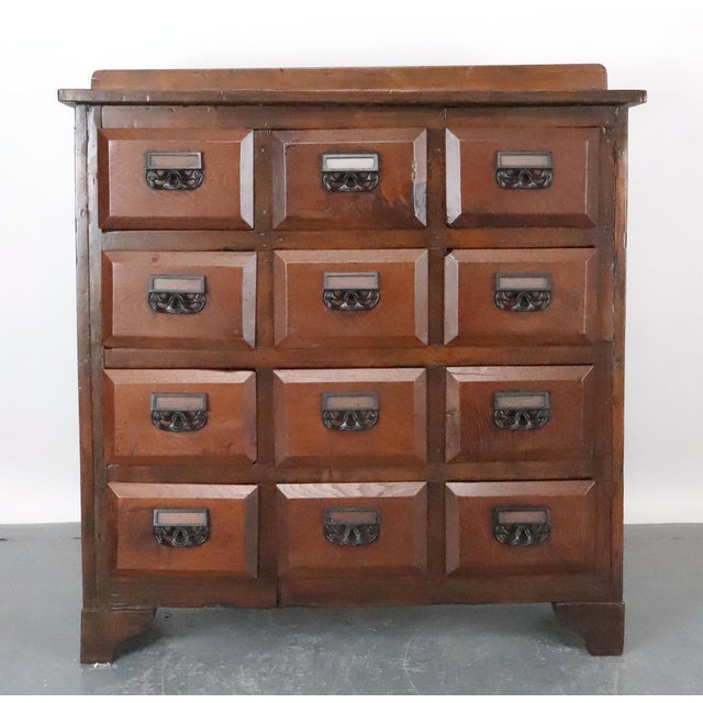 A classic example of an antique apothecary cabinet, also frequently used as a library card catalog or seed counter. These...