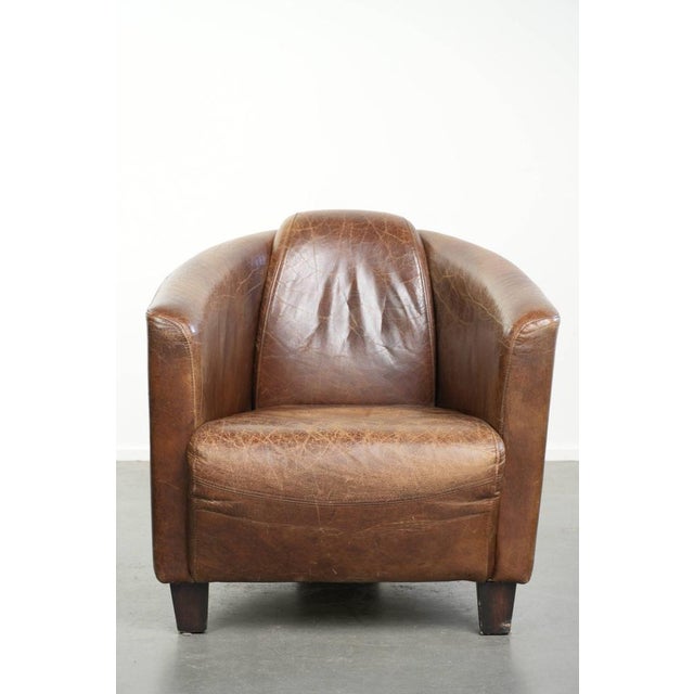 this robust cognac-colored cowhide Aviator design armchair with a striking and timeless appearance. This robust, cognac-...